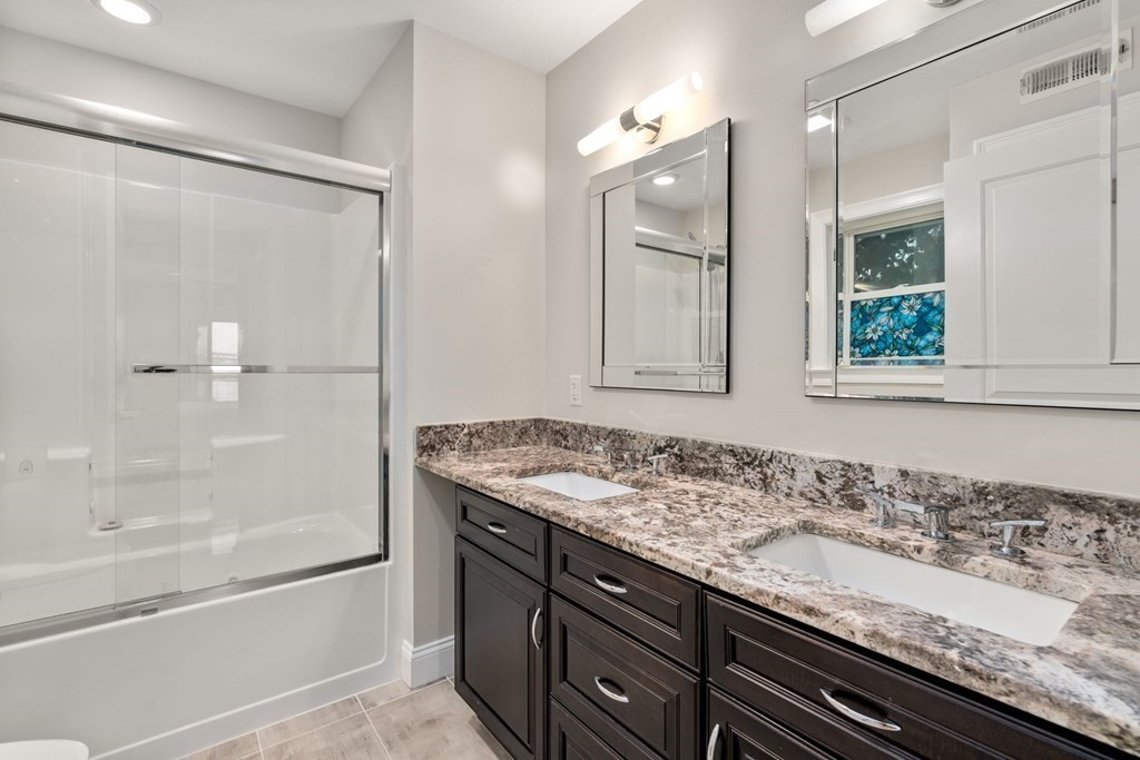 375 Border Street, Unit 375 Boston, MA 02128 - Photo 17 of 34 a bathroom with a granite countertop sink and a mirror