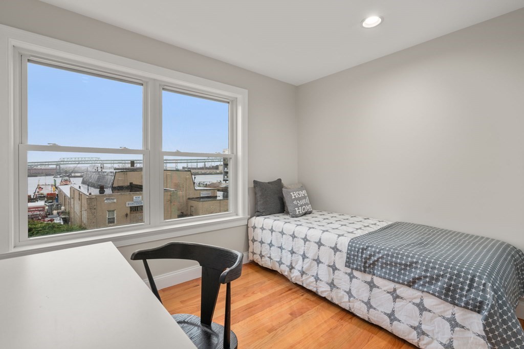 375 Border Street, Unit 375 Boston, MA 02128 - Photo 20 of 34 a bedroom with a bed and a large window