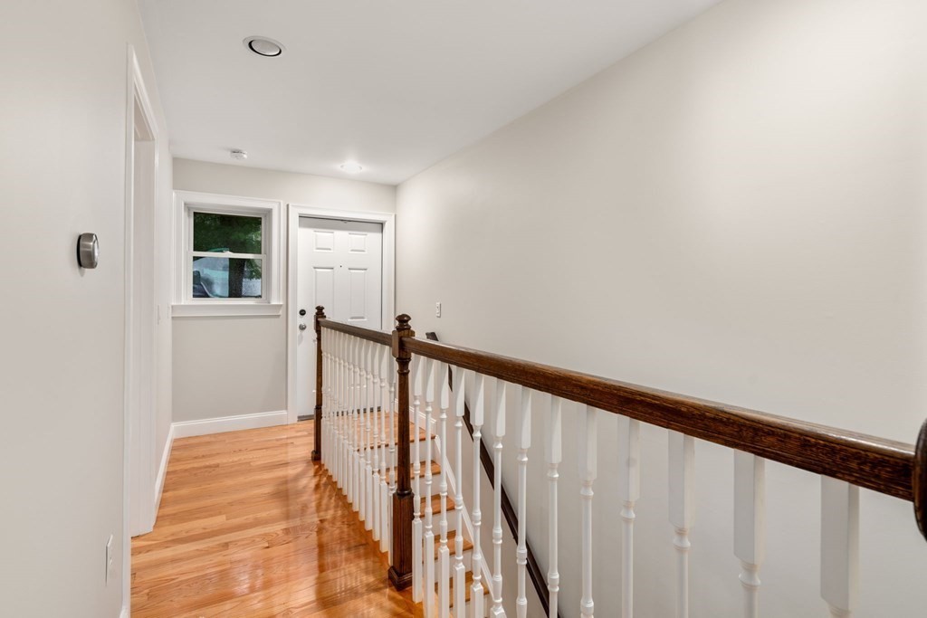 375 Border Street, Unit 375 Boston, MA 02128 - Photo 23 of 34 a view of a hallway with wooden floor and staircase