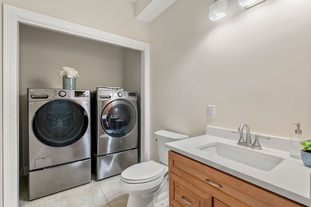 375 Border Street, Unit 375 Boston, MA 02128 - Photo 26 of 34 a bathroom with a granite countertop toilet sink and mirror