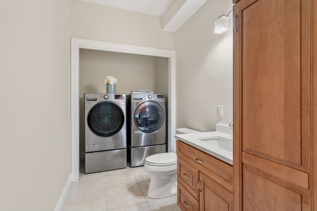 375 Border Street, Unit 375 Boston, MA 02128 - Photo 27 of 34 a bathroom with a sink a washer and dryer