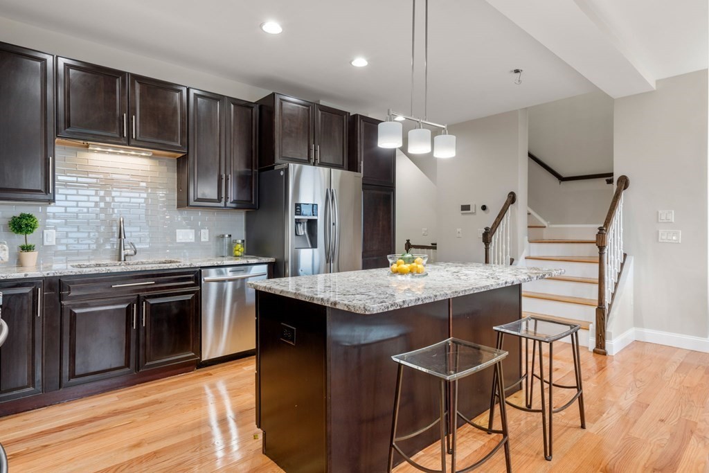 375 Border Street, Unit 375 Boston, MA 02128 - Photo 6 of 34 a kitchen with stainless steel appliances granite countertop a stove refrigerator sink and cabinets