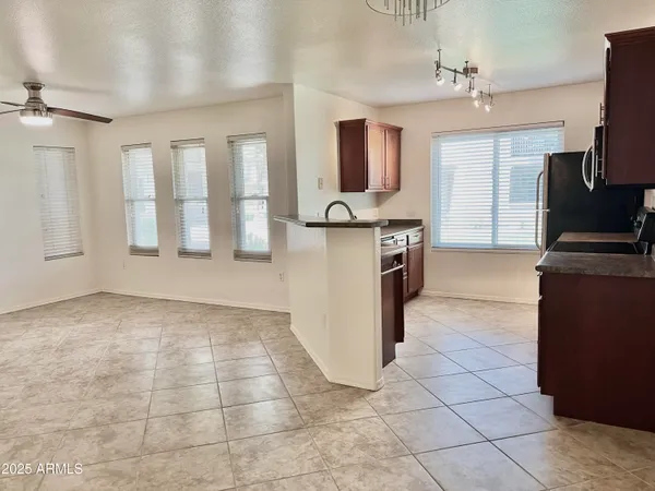 a open kitchen with cabinets and stainless steel appliances