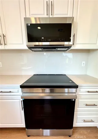 a stove top oven sitting inside of a kitchen