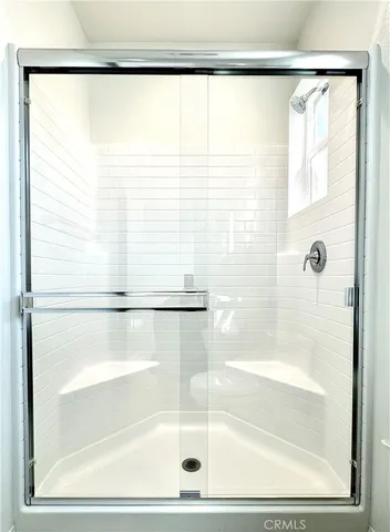 a bathroom with a glass shower door