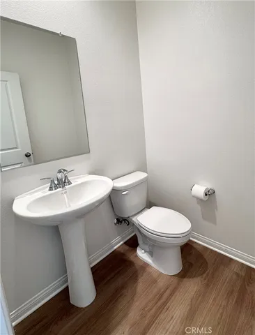 a white toilet sitting next to a bathroom sink