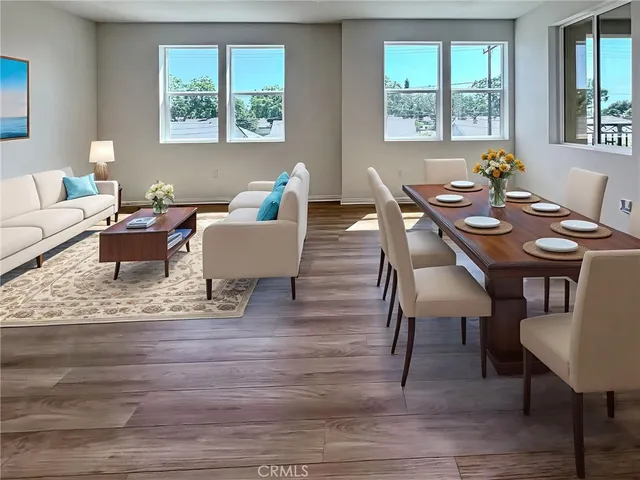 a view of a dining room with furniture a couch and wooden floor
