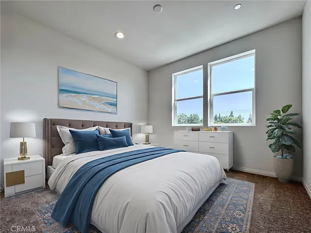 a bedroom with a large bed and a large window