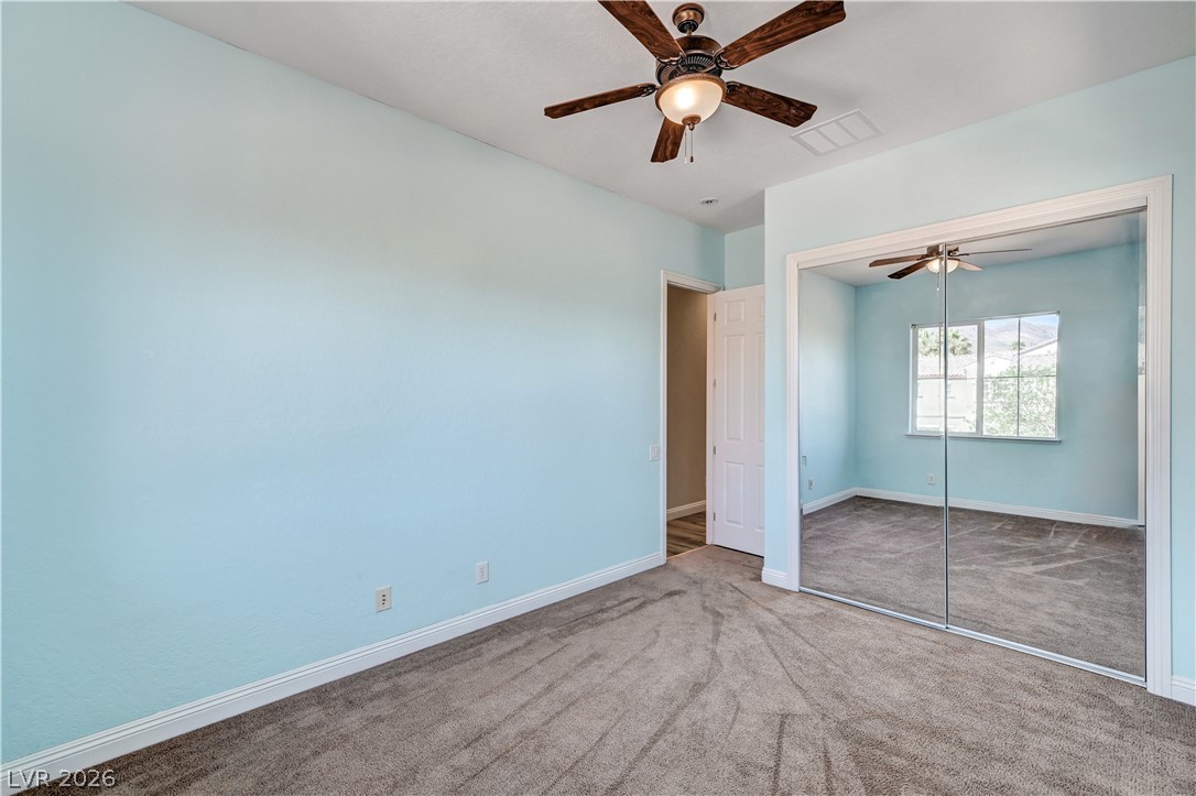 2793 Rosenhearty Drive Henderson, NV 89044 - Photo 51 of 77 A well-lit bedroom features plush carpeting and a convenient mirrored closet.