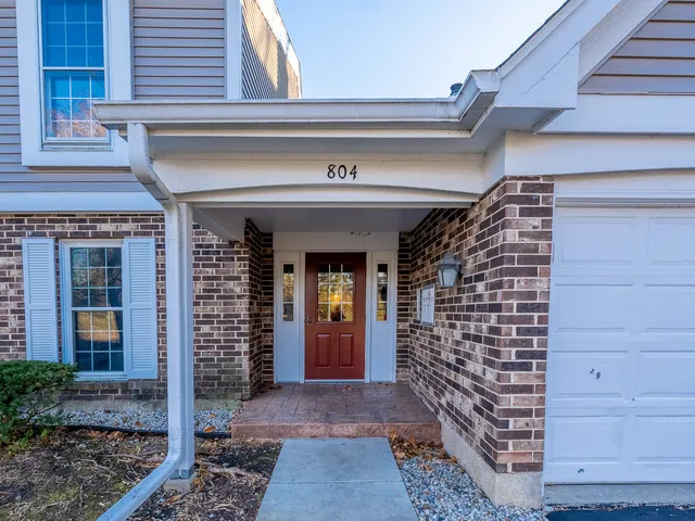 a view of a big room with wooden floor and windows