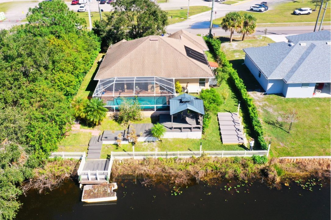 an aerial view of a house with swimming pool outdoor seating and yard