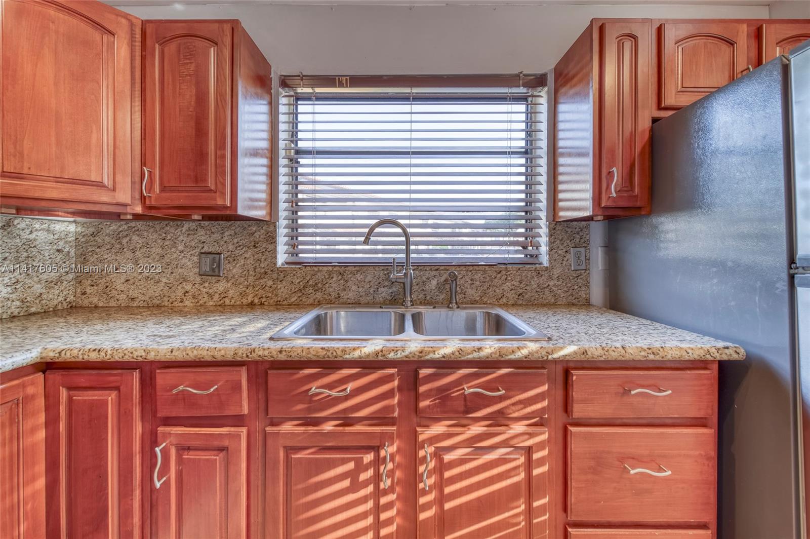 13440 Southwest 62nd Street, Unit G101 Miami, FL 33183 - Photo 12 of 25 a kitchen with granite countertop cabinets and window