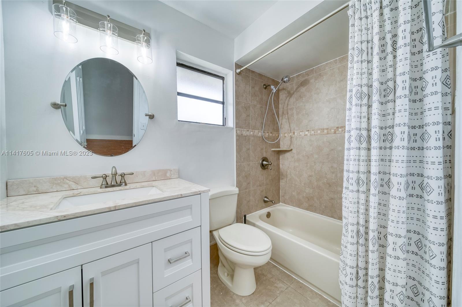 13440 Southwest 62nd Street, Unit G101 Miami, FL 33183 - Photo 19 of 25 a bathroom with a toilet sink and mirror