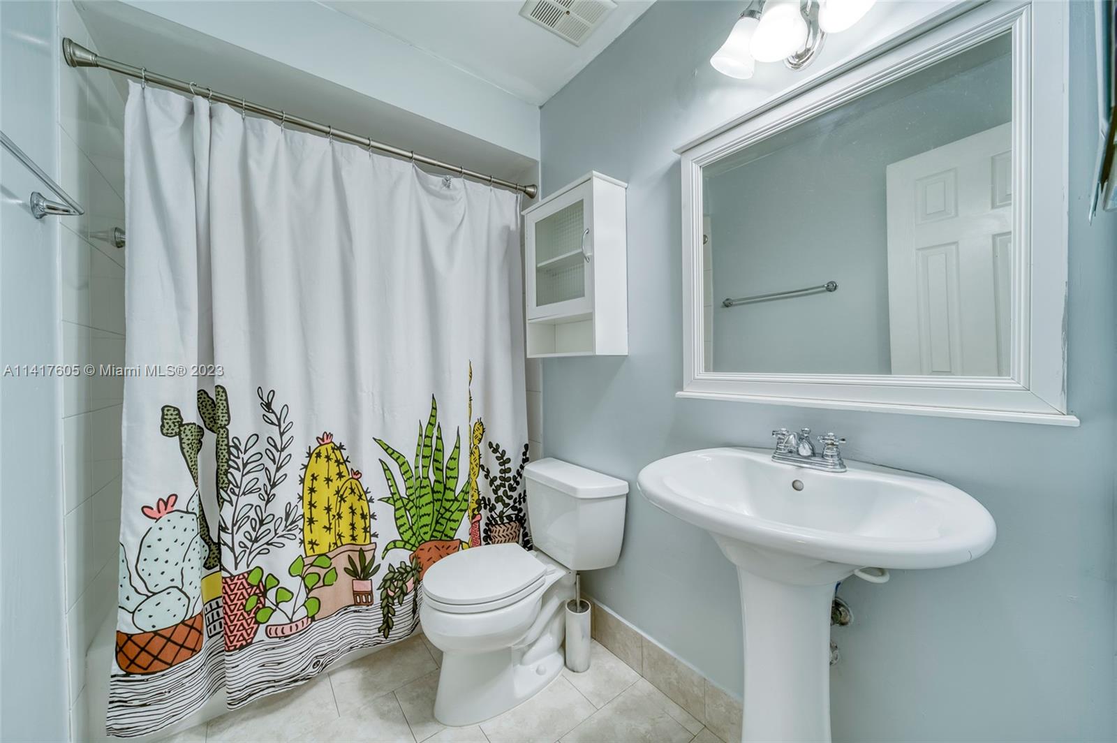 13440 Southwest 62nd Street, Unit G101 Miami, FL 33183 - Photo 20 of 25 a bathroom with a sink a toilet and a mirror