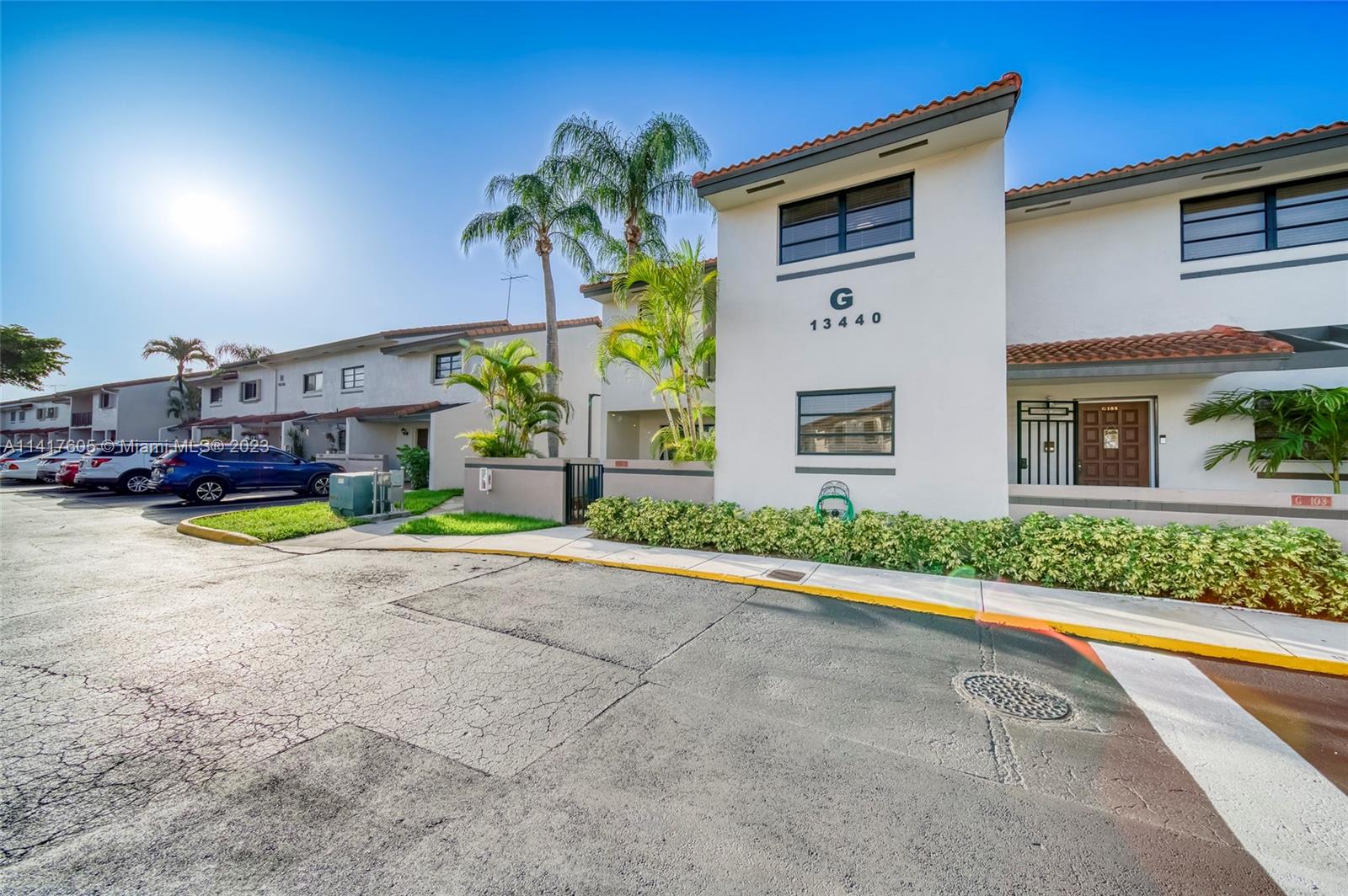 13440 Southwest 62nd Street, Unit G101 Miami, FL 33183 - Photo 2 of 25 a view of multiple houses with a yard