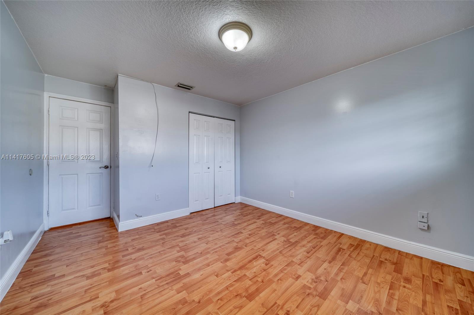 13440 Southwest 62nd Street, Unit G101 Miami, FL 33183 - Photo 22 of 25 an empty room with wooden floor and windows