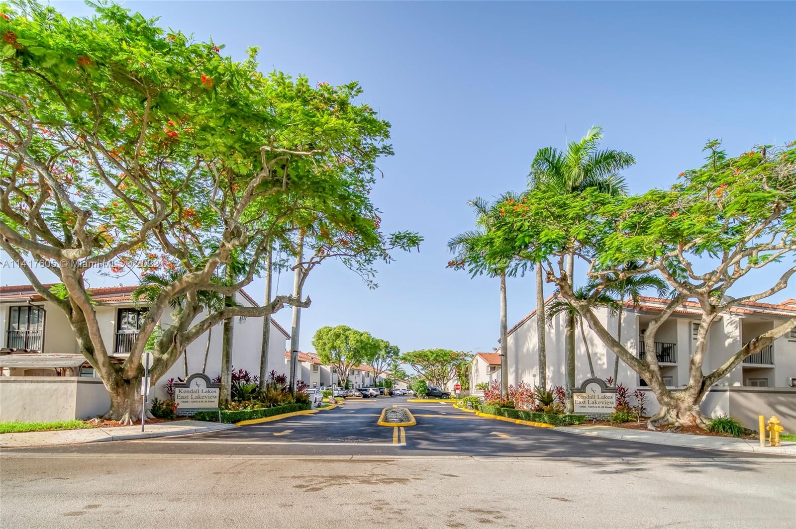 13440 Southwest 62nd Street, Unit G101 Miami, FL 33183 - Photo 25 of 25 a street view with large trees