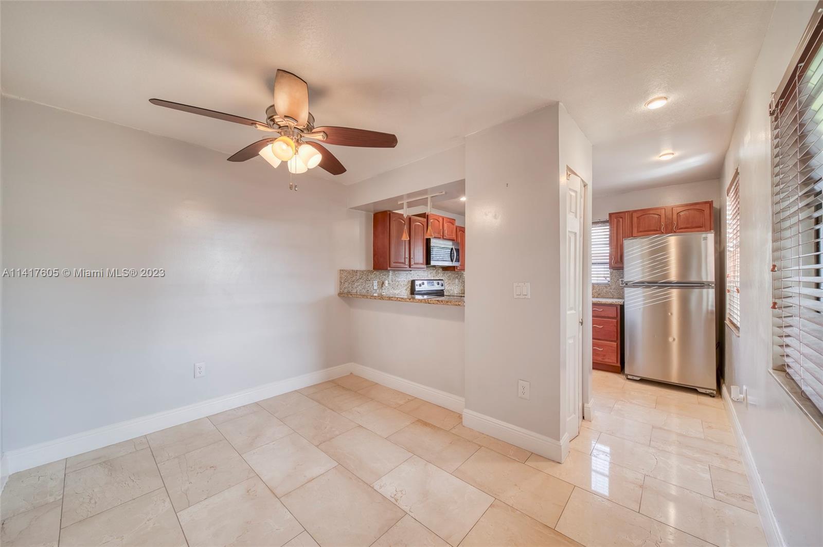 13440 Southwest 62nd Street, Unit G101 Miami, FL 33183 - Photo 9 of 25 a view of empty room with wooden floor and fan