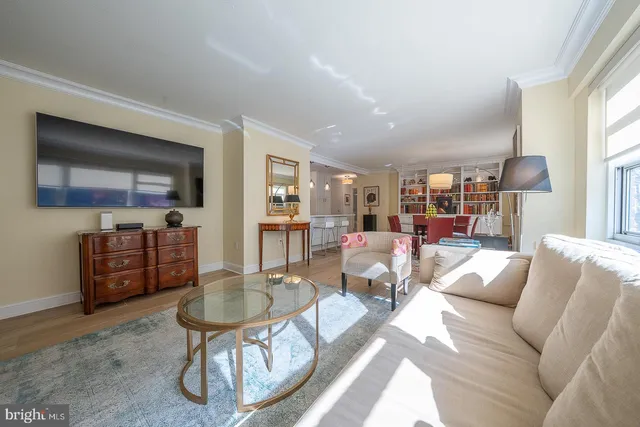 a living room with furniture a lamp and a large window