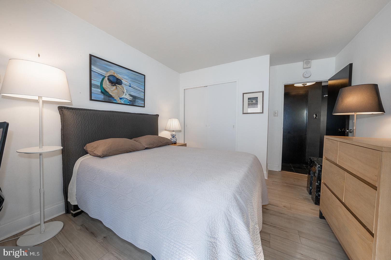 118 South 21st Street, Unit 31112 Philadelphia, PA 19103 - Photo 11 of 26 a bedroom with a bed and a lamp