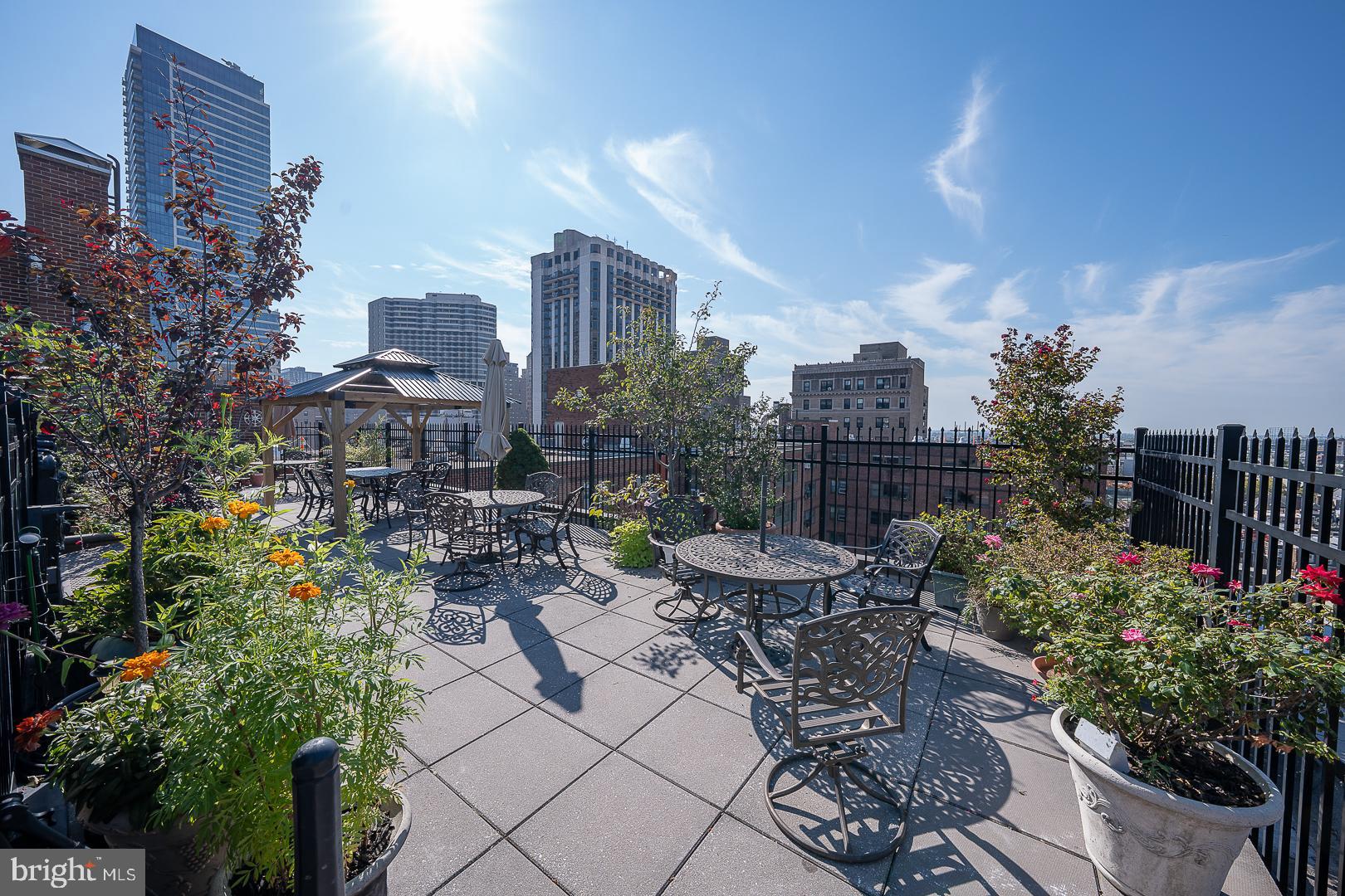 118 South 21st Street, Unit 31112 Philadelphia, PA 19103 - Photo 25 of 26 a view of a patio with table and chairs and potted plants