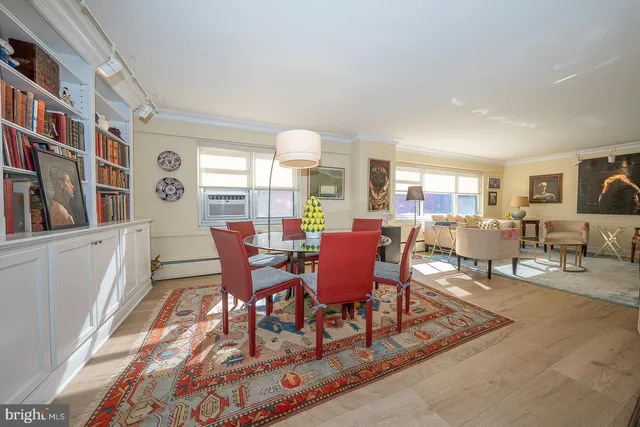 a dining room with wooden floor and furniture