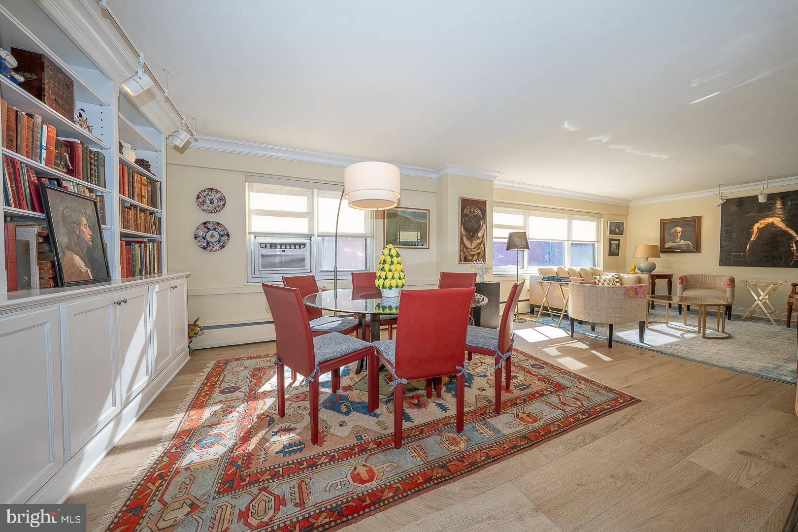 118 South 21st Street, Unit 31112 Philadelphia, PA 19103 - Photo 3 of 26 a dining room with wooden floor and furniture