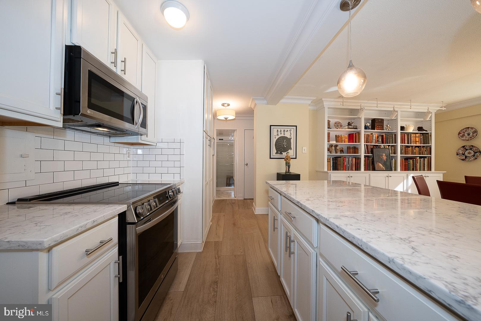 118 South 21st Street, Unit 31112 Philadelphia, PA 19103 - Photo 8 of 26 a kitchen with stainless steel appliances granite countertop a stove a sink and a microwave