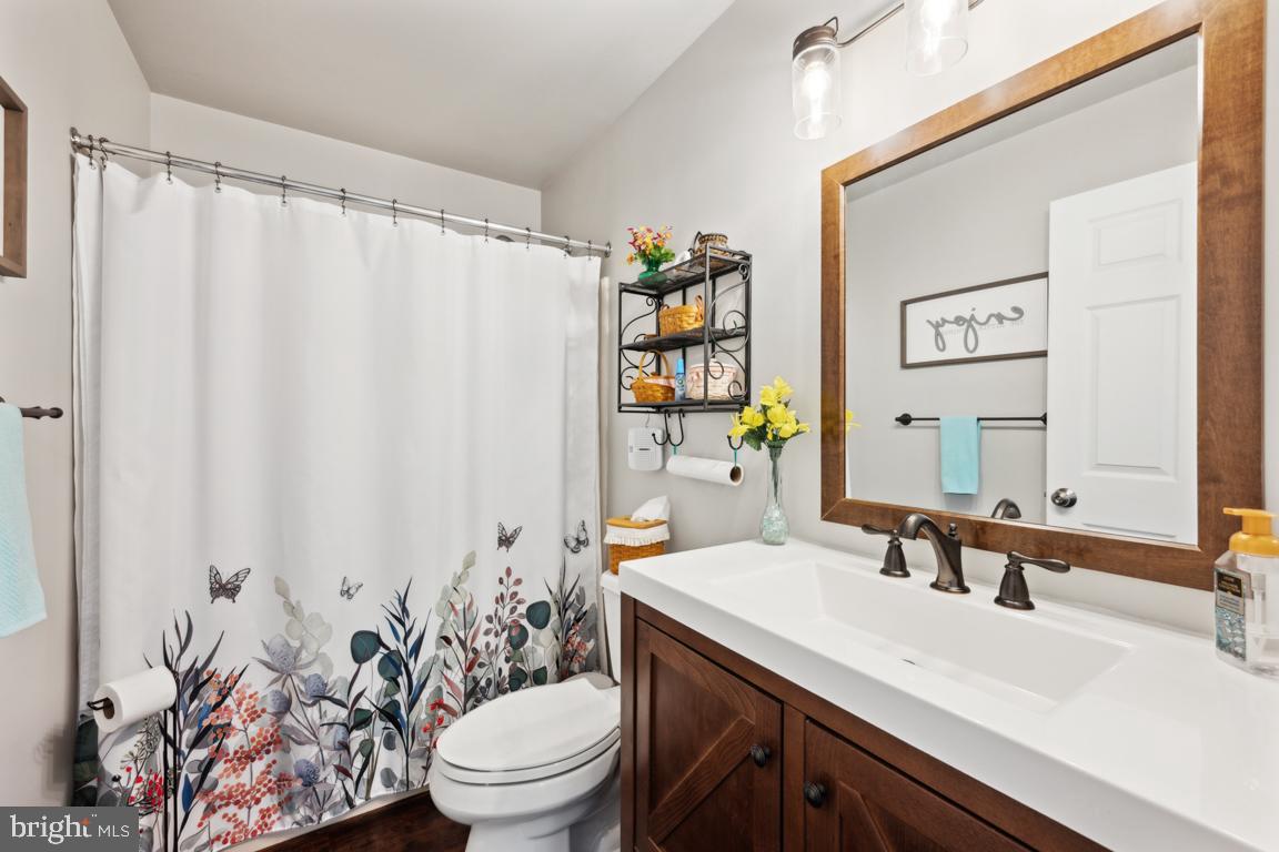 1009 Squirrel Road Marlton, NJ 08053 - Photo 6 of 29 a bathroom with a sink a toilet and shower curtain