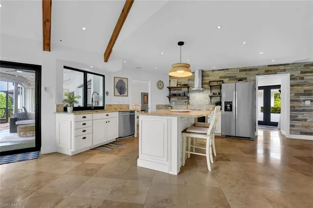 a kitchen with a sink stainless steel appliances and cabinets