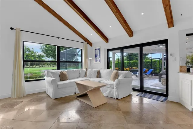 a living room with couch and a large window