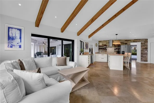 a living room with furniture and kitchen view