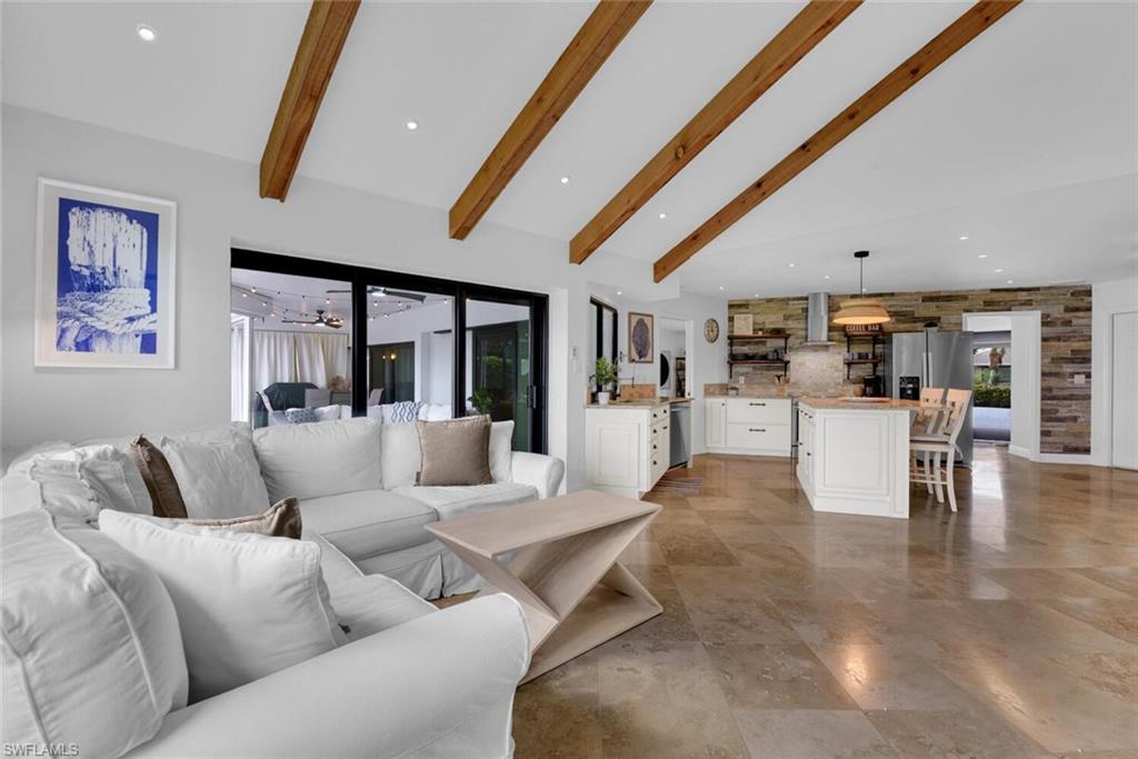 167 Torrey Pines Point Naples, FL 34113 - Photo 17 of 37 a living room with furniture and kitchen view