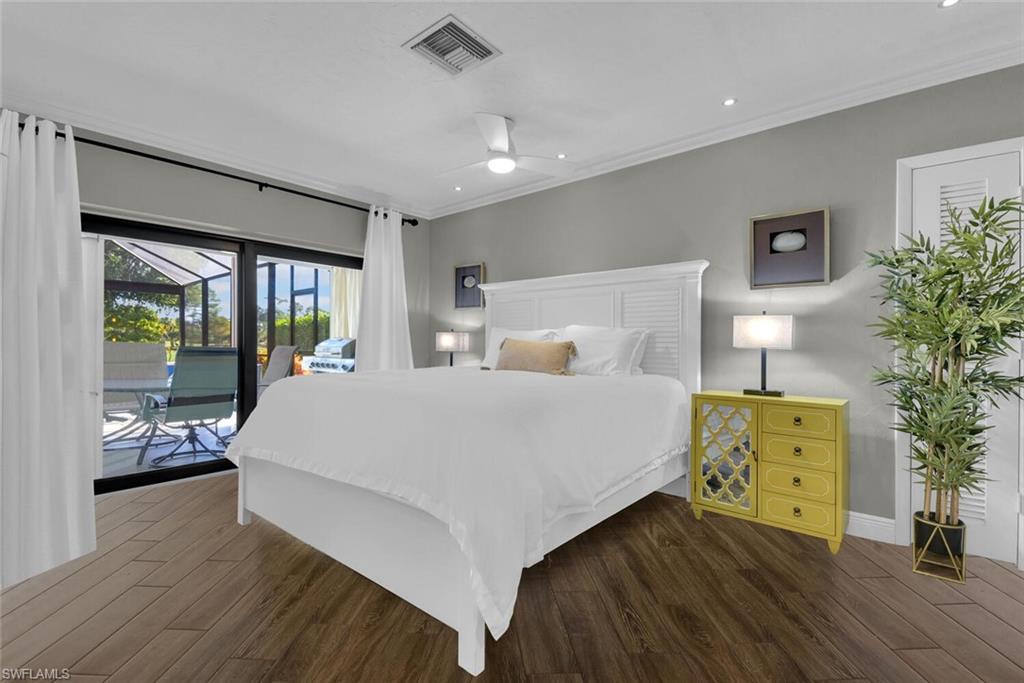 167 Torrey Pines Point Naples, FL 34113 - Photo 18 of 37 a bedroom with a bed and wooden floor
