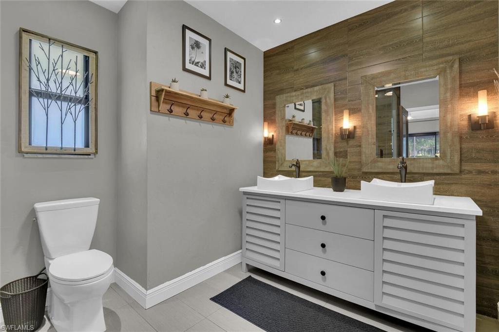 167 Torrey Pines Point Naples, FL 34113 - Photo 21 of 37 a bathroom with a toilet sink and mirror