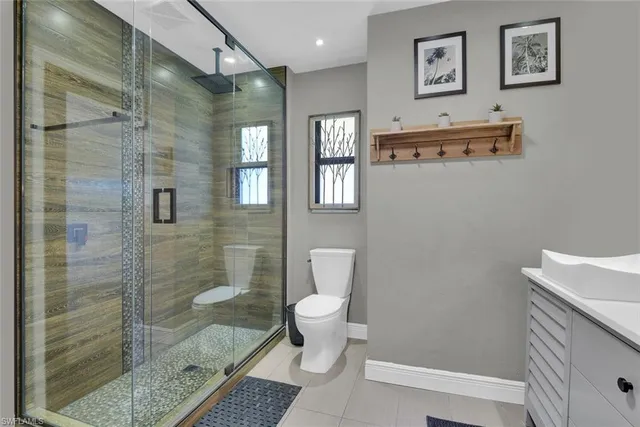 a bathroom with a shower sink and toilet