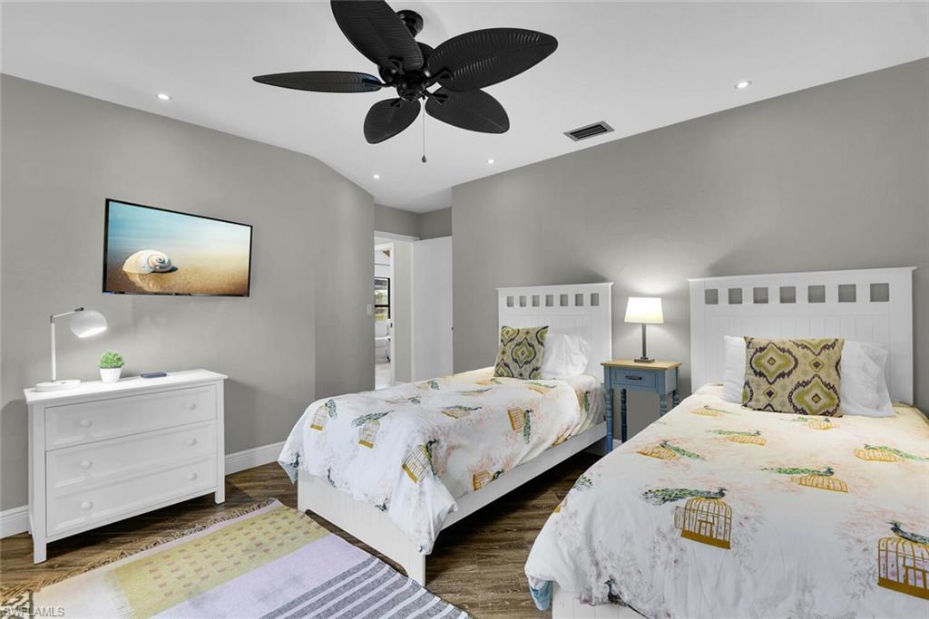 167 Torrey Pines Point Naples, FL 34113 - Photo 23 of 37 a bedroom with two beds and a chandelier