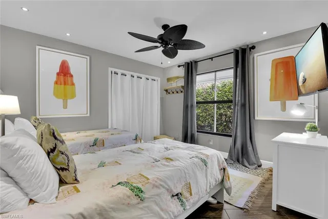 a bedroom with a bed and a large window