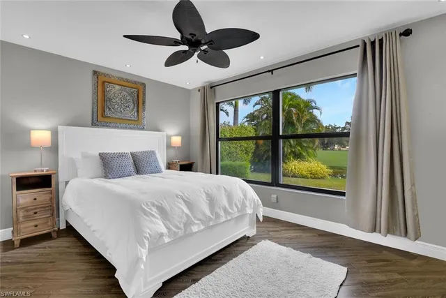 a bedroom with a large bed and a window