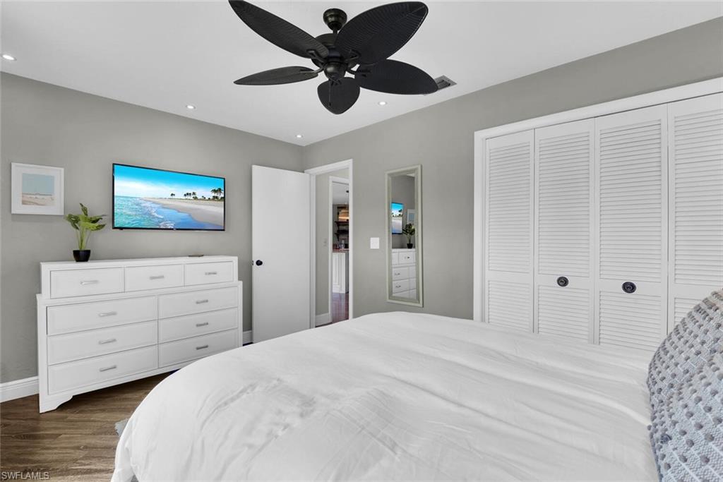 167 Torrey Pines Point Naples, FL 34113 - Photo 27 of 37 a bedroom with a bed and a chandelier