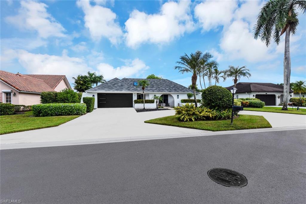 167 Torrey Pines Point Naples, FL 34113 - Photo 3 of 37 a white house with a large tree in front of it