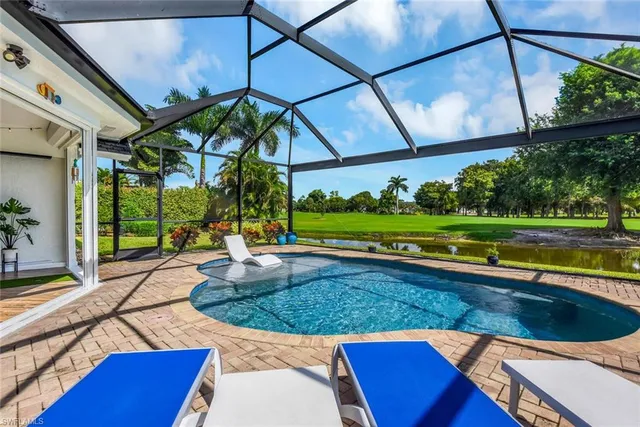 a view of a backyard with swimming pool