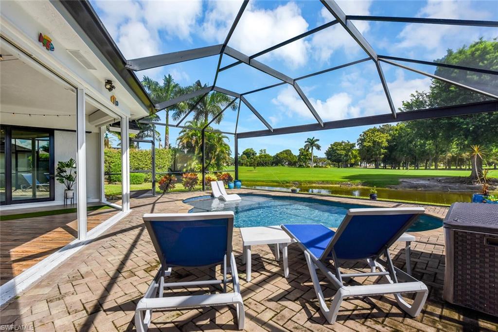 167 Torrey Pines Point Naples, FL 34113 - Photo 33 of 37 a view of a patio with table and chairs potted plants and large tree