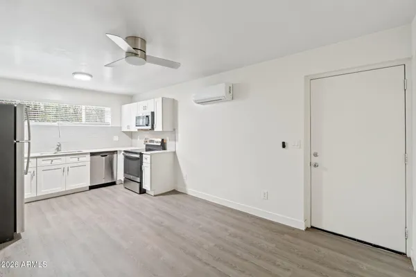 a kitchen with a stove top oven and white cabinets
