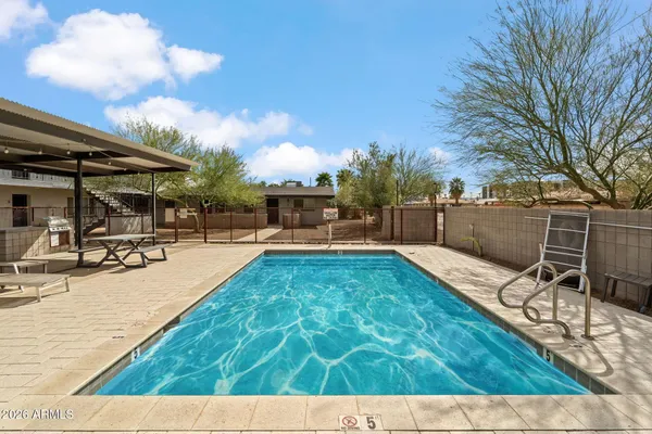 a view of a swimming pool with a patio