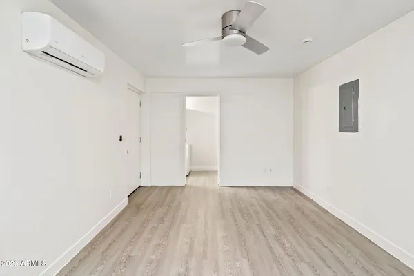 a view of room with wooden floor and ceiling fan