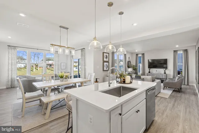 a large kitchen with a table and chairs