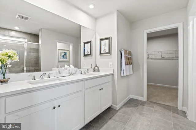 a bathroom with a double vanity sink and mirror