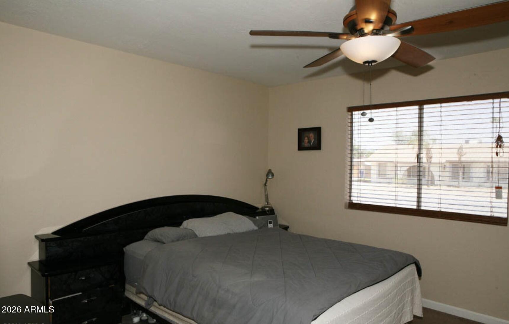 911 West Colgate Drive Tempe, AZ 85283 - Photo 12 of 15 a bedroom with a bed and a chandelier