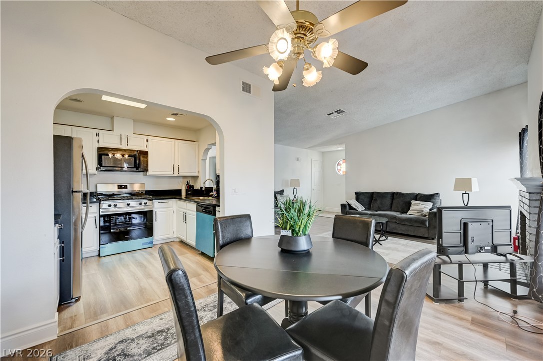 1751 East Reno Avenue, Unit 228 Las Vegas, NV 89119 - Photo 12 of 39 An inviting open-concept layout seamlessly connects the kitchen to the dining and living areas.